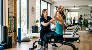 A professional, editorial-style photograph depicting a physical therapist guiding a patient through